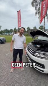 Medewerker van FloorDeals bij een auto met open motorkap